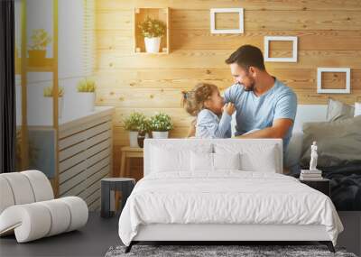 happy family father and   daughter laughing and playing in bed. Wall mural