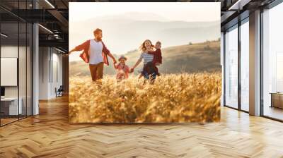 Happy family father of mother and child son  on nature at sunset Wall mural