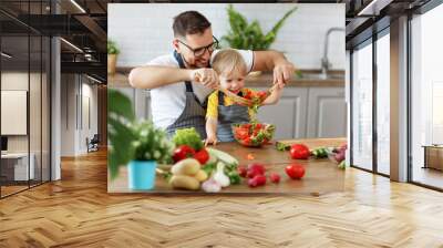 happy family father with son preparing vegetable salad Wall mural