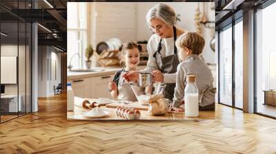 happy family grandmother and grandchildren cook in the kitchen, knead dough, bake cookies. Wall mural