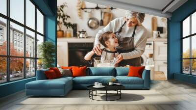 happy family grandmother and granddaughter child cook in the kitchen, knead dough, bake cookies Wall mural