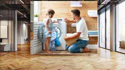 happy family man father householder and child in laundry with washing machine Wall mural