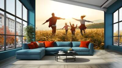 Happy family: mother, father, children son and daughter on sunset. Wall mural