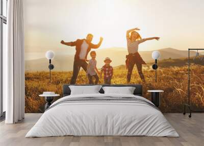 Happy family: mother, father, children son and daughter on sunset Wall mural