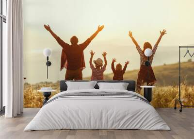 Happy family: mother, father, children son and daughter on sunset Wall mural