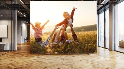 Happy family: mother, father, children son and daughter on sunset Wall mural