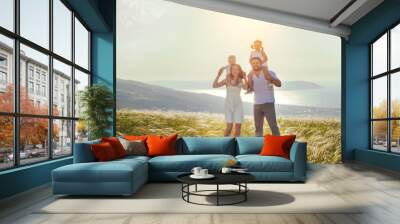 Happy family: mother, father, children son and daughter on sunset Wall mural