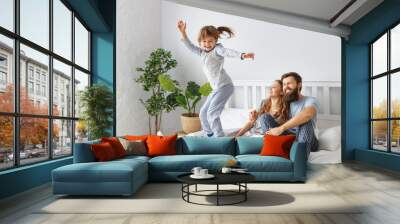 happy family mother, father and child  in bed Wall mural