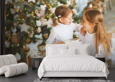 happy family mother and child daughter on Christmas morning  tre Wall mural