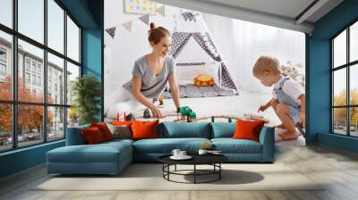 happy family mother and child son playing   in toy railway in playroom Wall mural