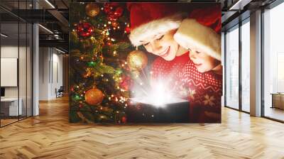 happy family mother and child with magical Christmas gift Wall mural