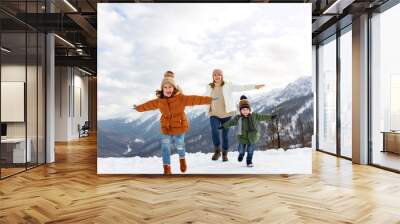 happy family mother and children having fun on winter walk Wall mural