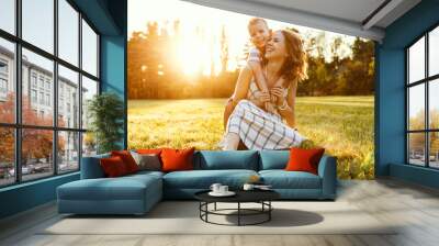 Happy family: mother and son hugging in nature in summer Wall mural