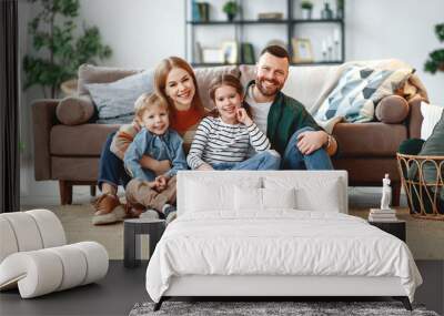 happy family mother father and kids at home on couch . Wall mural