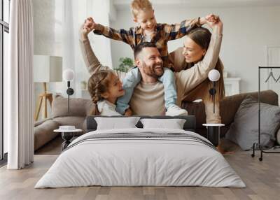 happy family mother father and kids at home on couch . Wall mural