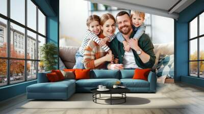 happy family mother father and kids at home on couch . Wall mural