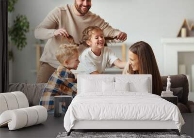 happy family mother father and kids having fun at home on couch Wall mural