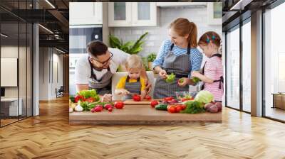 happy family with children preparing vegetable salad . Wall mural