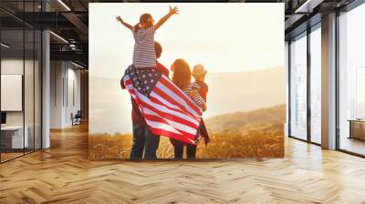 happy family with flag of america USA at sunset outdoors. Wall mural