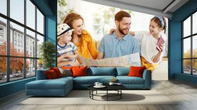 Happy family with map and passports planning travel. Wall mural