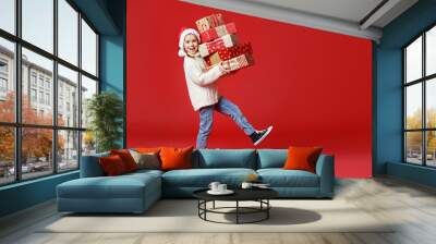 happy funny child girl    with Christmas gift on red   background Wall mural