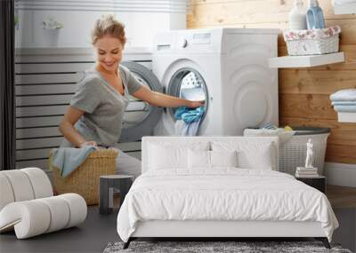 Happy housewife woman in laundry room with washing machine Wall mural