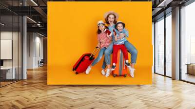 happy journey! family of travelers mother and children with suitcases tickets and passports on yellow background. Wall mural