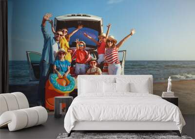 happy large family  in summer auto journey travel by car on beach. Wall mural