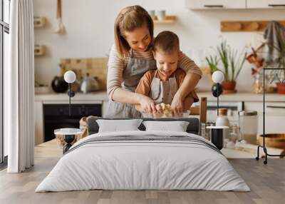 Happy mother and son preparing dough together Wall mural