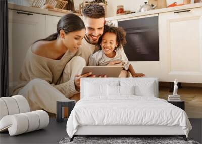 happy multi ethnic family: parents and son using tablet  at home Wall mural