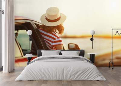 happy woman girl goes to summer travel trip in   car. Wall mural