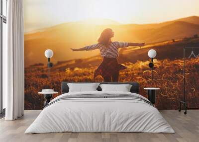 Happy woman jumping and enjoying life  at sunset in mountains. Wall mural