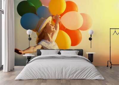 happy woman with balloons at sunset in summer Wall mural