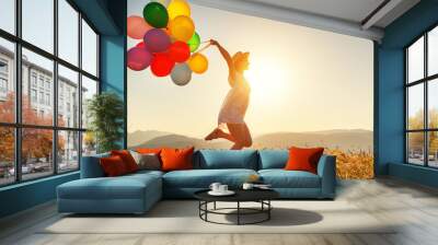 happy woman with balloons at sunset in summer Wall mural