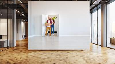 happy young married couple moves to new apartment Wall mural