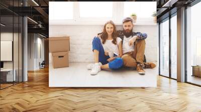 happy young married couple moves to new apartment Wall mural