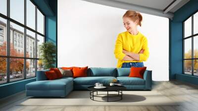 happy young woman in yellow sweater on white background. Wall mural