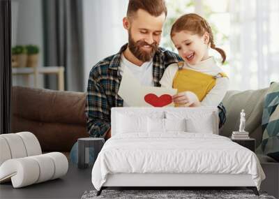 Little girl giving greeting card to dad. Wall mural