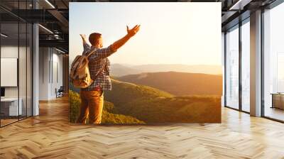 Male tourist on top of mountain in fog in autumn Wall mural