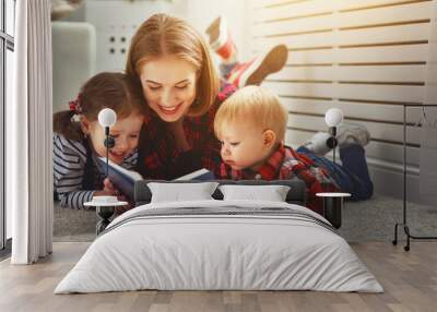 Mother reads book to children Wall mural