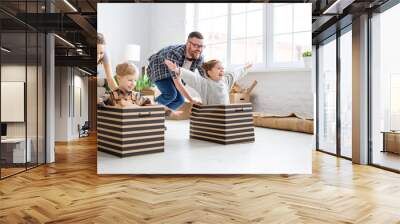 Optimistic family having fun during relocation in new flat Wall mural