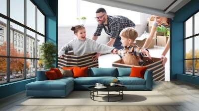 Optimistic family having fun during relocation in new flat Wall mural