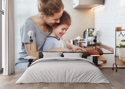 preparation of family breakfast. mother and child daughter cut bread and cheese in morning Wall mural