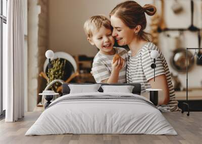 preparation of family breakfast. mother and child son cut bread  and eat cookies with milk in morning Wall mural