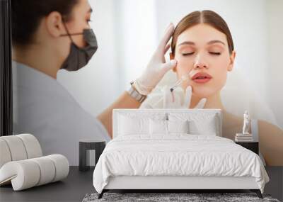 Woman getting beauty injection in salon Wall mural