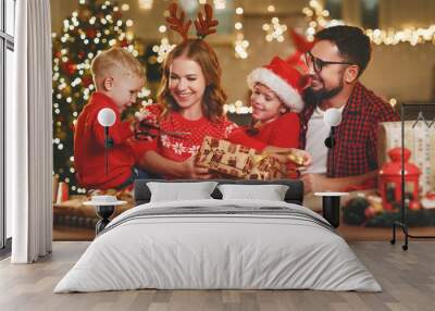 y family mother, father and children pack Christmas gifts. Wall mural