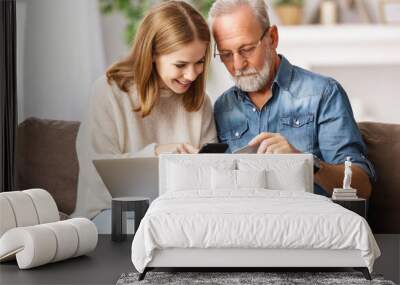 Young woman with father shopping online at home. Wall mural