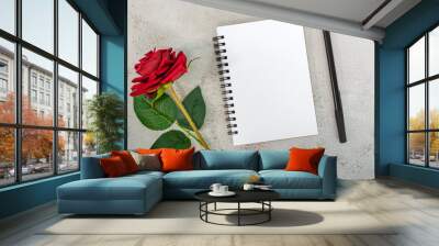 Note book with red roses and pen on marble desk. Top view. Flat lay. Copy space. Wall mural