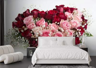 A heart-shaped bouquet of red and pink roses with baby's breath on a white surface. Valentine's Day, February 14 Wall mural