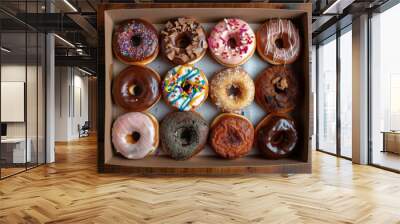 Indulge in a mouthwatering assortment of donuts, each one adorned with a tempting variety of flavors and delectable toppings. Wall mural